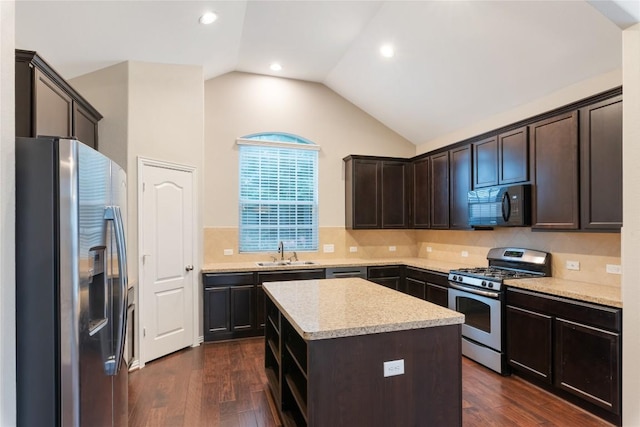 217 Orchard Hill Trl, Buda, TX 78610 - kitchen featuring stainless steel appliances, a sink, dark wood-style flooring, vaulted ceiling, and light countertops