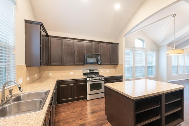 217 Orchard Hill Trl, Buda, TX 78610 - kitchen featuring stainless steel gas range, black microwave, a sink, lofted ceiling, and dark brown cabinetry