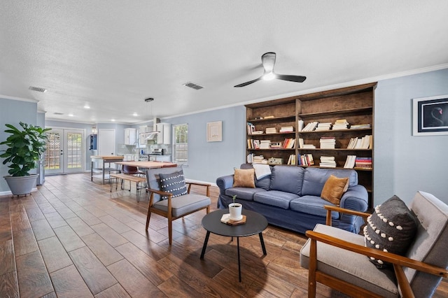6725 Broad Brook Dr, Austin, TX 78747 - living room with crown molding, baseboards, dark wood-style flooring, ceiling fan, and a textured ceiling