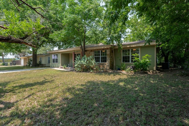 1203 Haynes St, San Marcos, TX 78666 - single story home featuring a front yard, a garage, driveway, and stone siding