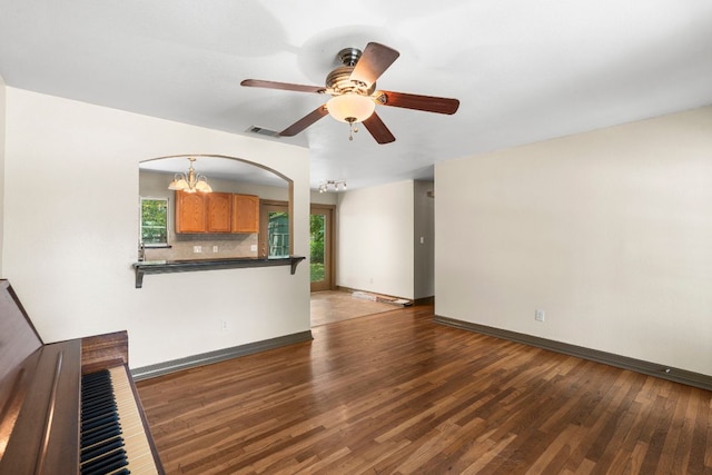 1203 Haynes St, San Marcos, TX 78666 - unfurnished living room with healthy amount of natural light, wood finished floors, a chandelier, and ceiling fan