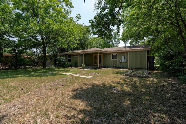 1203 Haynes St, San Marcos, TX 78666 - rear view of property featuring a yard