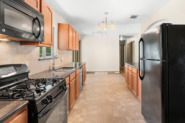 1203 Haynes St, San Marcos, TX 78666 - kitchen featuring black appliances, decorative backsplash, a chandelier, decorative light fixtures, and dark stone countertops