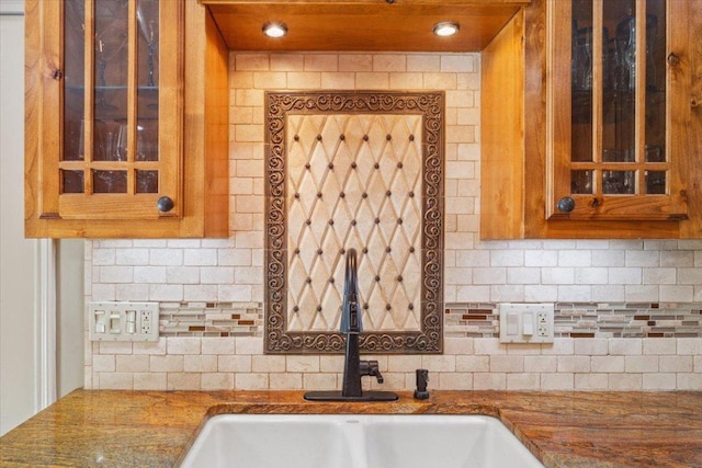 2901 Olympia Dr, Temple, TX 76502 - kitchen featuring a sink, backsplash, glass insert cabinets, and brown cabinets