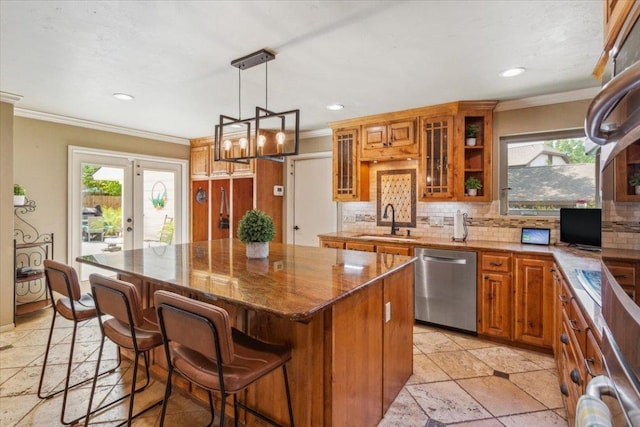 2901 Olympia Dr, Temple, TX 76502 - kitchen with stainless steel dishwasher, a sink, brown cabinetry, a kitchen island, and tasteful backsplash