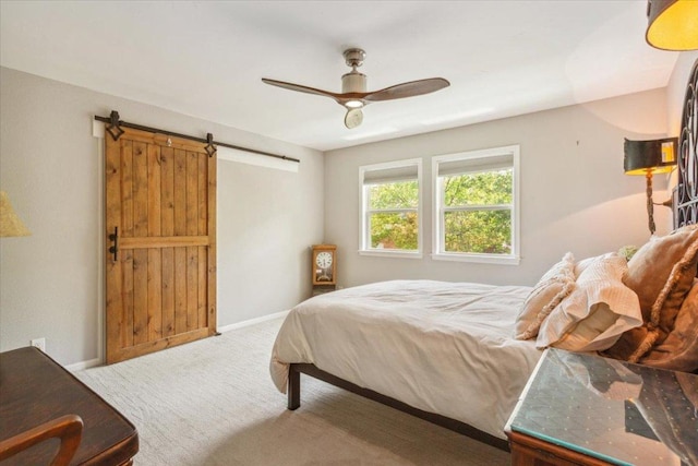 2901 Olympia Dr, Temple, TX 76502 - carpeted bedroom featuring a barn door, ceiling fan, and baseboards