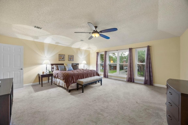 1303 Shady Grove Path, Cedar Park, TX 78613 - bedroom featuring light carpet, a textured ceiling, baseboards, and ceiling fan