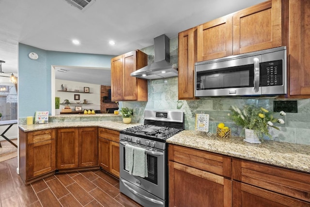 1303 Shady Grove Path, Cedar Park, TX 78613 - kitchen with appliances with stainless steel finishes, wall chimney range hood, backsplash, light stone counters, and recessed lighting