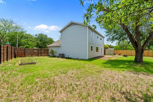 11708 Rotherham Dr, Austin, TX 78753 - rear view of house with a fenced backyard and a vegetable garden