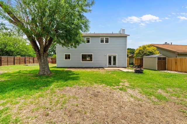 11708 Rotherham Dr, Austin, TX 78753 - rear view of house with french doors, a storage unit, a fenced backyard, a chimney, and an outdoor fire pit