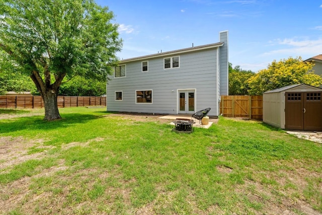 11708 Rotherham Dr, Austin, TX 78753 - rear view of house featuring french doors, a fire pit, a fenced backyard, a storage unit, and a chimney