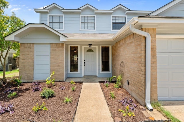 11708 Rotherham Dr, Austin, TX 78753 - view of exterior entry featuring brick siding, a garage, and a porch