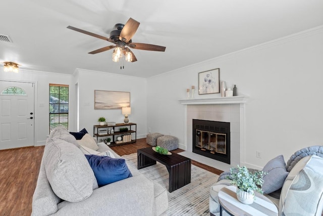 11708 Rotherham Dr, Austin, TX 78753 - living room with crown molding, wood finished floors, a fireplace, and a ceiling fan