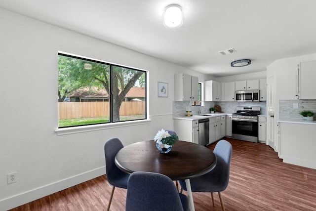 11708 Rotherham Dr, Austin, TX 78753 - dining area with dark wood-type flooring and baseboards