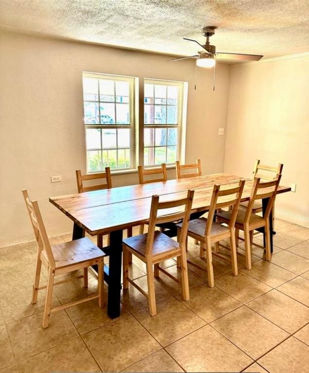 101 Byrne St, Smithville, TX 78957 - dining room featuring a textured ceiling, light tile patterned flooring, a ceiling fan, and baseboards