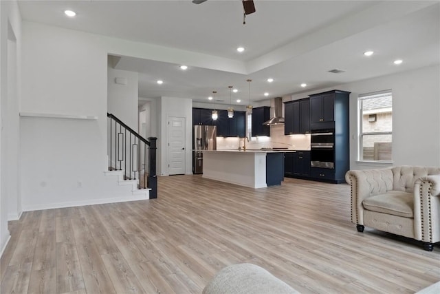 3437 Jaulan St, Leander, TX 78641 - living room featuring light wood-style floors, stairs, a ceiling fan, recessed lighting, and baseboards
