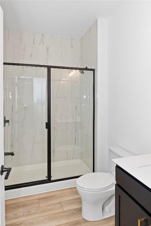 3437 Jaulan St, Leander, TX 78641 - bathroom with toilet, a marble finish shower, vanity, and wood finished floors