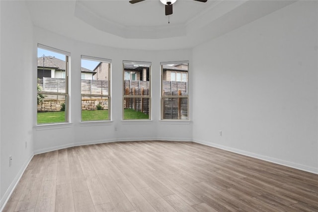 3437 Jaulan St, Leander, TX 78641 - unfurnished room with a tray ceiling, ceiling fan, wood finished floors, baseboards, and ornamental molding