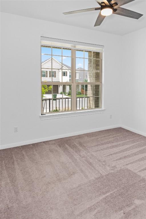3437 Jaulan St, Leander, TX 78641 - carpeted empty room with a ceiling fan and baseboards