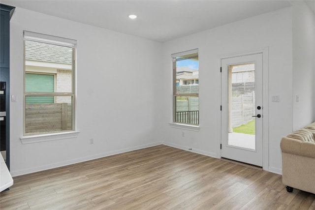 3437 Jaulan St, Leander, TX 78641 - doorway to outside featuring light wood-style flooring, baseboards, and recessed lighting