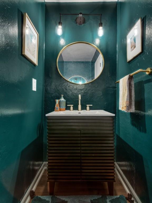 bathroom with vanity and baseboards