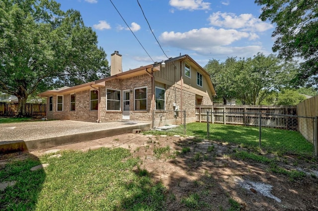 1605 Woods Blvd, Round Rock, TX 78681 - rear view of house featuring a chimney, a patio, and brick siding