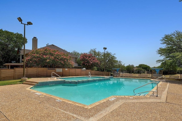 1605 Woods Blvd, Round Rock, TX 78681 - community pool featuring a fenced backyard, a hot tub, and a patio area