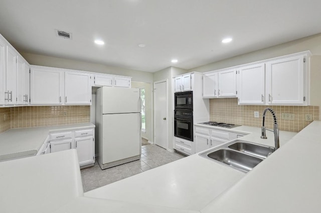 1605 Woods Blvd, Round Rock, TX 78681 - kitchen featuring black appliances, a sink, tasteful backsplash, white cabinets, and light countertops