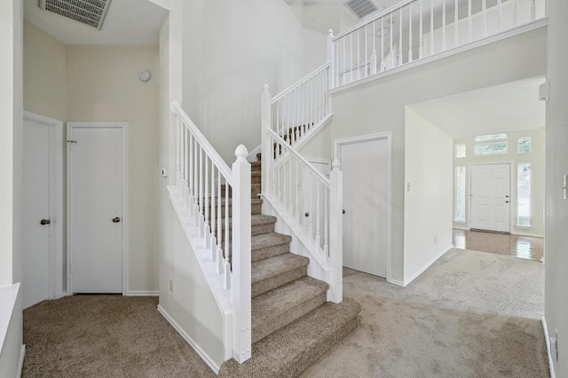 1605 Woods Blvd, Round Rock, TX 78681 - stairway with carpet flooring, a high ceiling, and baseboards