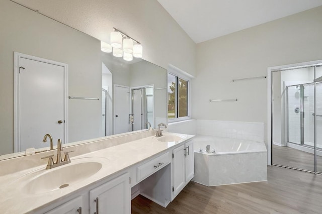 1605 Woods Blvd, Round Rock, TX 78681 - bathroom with wood finished floors, a stall shower, a garden tub, and double vanity