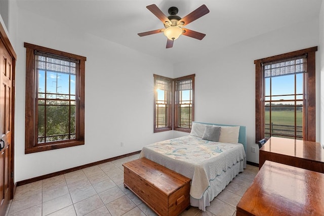 611 Post Oak Dr, Dripping Springs, TX 78620 - bedroom featuring baseboards, light tile patterned floors, and ceiling fan