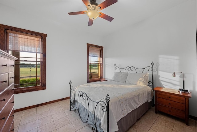 611 Post Oak Dr, Dripping Springs, TX 78620 - bedroom featuring multiple windows, light tile patterned floors, and baseboards