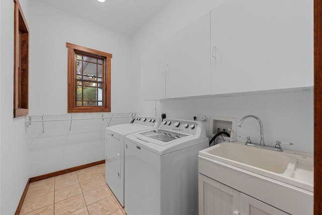 611 Post Oak Dr, Dripping Springs, TX 78620 - washroom with washing machine and clothes dryer, cabinet space, baseboards, and light tile patterned flooring