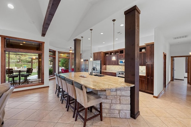 611 Post Oak Dr, Dripping Springs, TX 78620 - kitchen with a sink, tasteful backsplash, light tile patterned flooring, a breakfast bar area, and recessed lighting