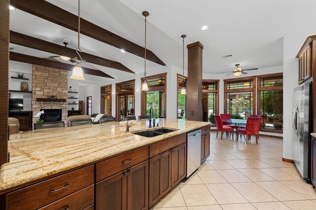 611 Post Oak Dr, Dripping Springs, TX 78620 - kitchen featuring ceiling fan, stainless steel appliances, a sink, a fireplace, and hanging light fixtures