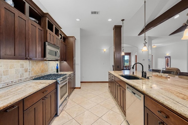 611 Post Oak Dr, Dripping Springs, TX 78620 - kitchen with stainless steel appliances, a sink, decorative backsplash, decorative light fixtures, and light stone countertops