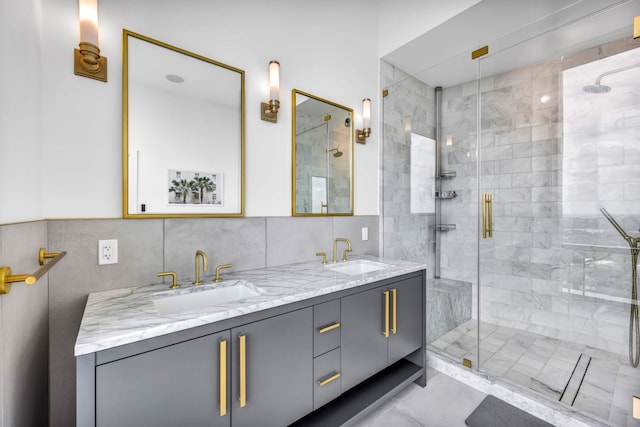 bathroom featuring a stall shower, tile walls, and double vanity