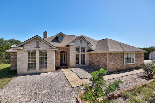 498 Aspen Cir, Killeen, TX 76549 - rear view of property featuring a chimney, a shingled roof, and stone siding