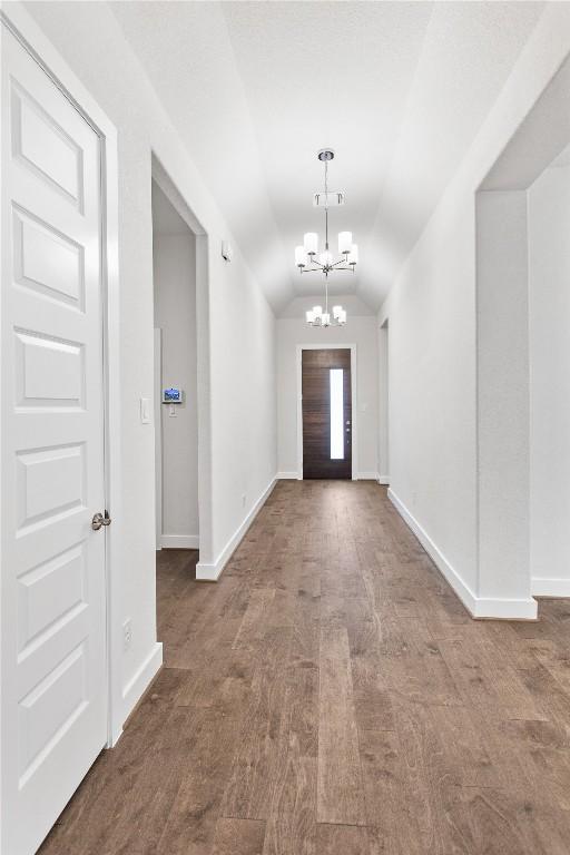 422 Sitlington Ln, Austin, TX 78738 - foyer entrance with lofted ceiling, a chandelier, baseboards, and wood finished floors