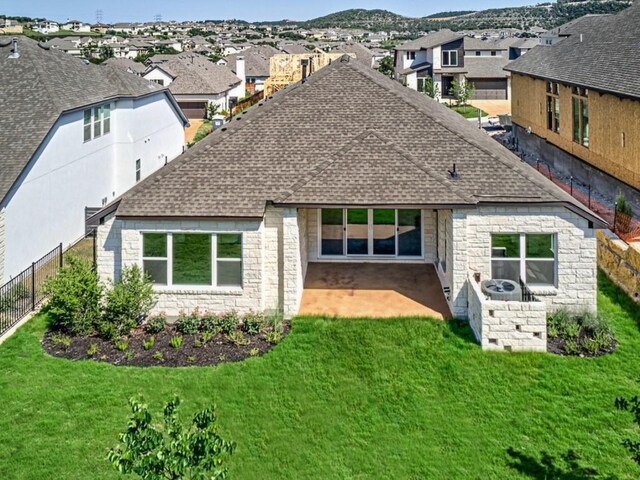 422 Sitlington Ln, Austin, TX 78738 - back of house with a shingled roof, stone siding, a residential view, and a patio area