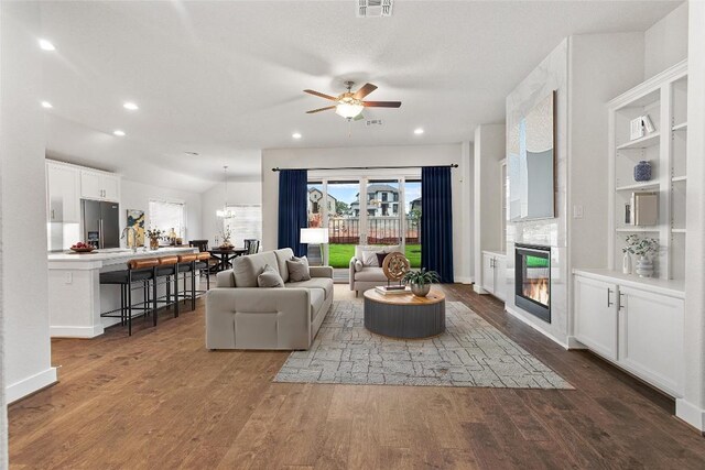 422 Sitlington Ln, Austin, TX 78738 - living room with a glass covered fireplace, ceiling fan, plenty of natural light, dark wood-type flooring, and recessed lighting