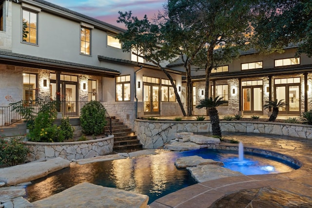 11949 Overlook Pass, Austin, TX 78738 - pool at dusk featuring stairway and french doors