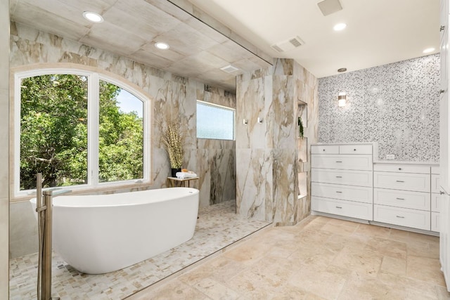 11949 Overlook Pass, Austin, TX 78738 - full bathroom featuring a freestanding bath, a walk in shower, tile walls, and recessed lighting