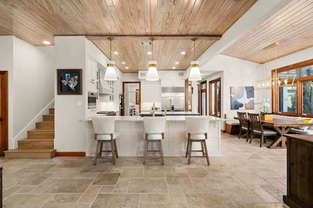 11949 Overlook Pass, Austin, TX 78738 - kitchen with wooden ceiling, stone tile floors, recessed lighting, white cabinets, and appliances with stainless steel finishes