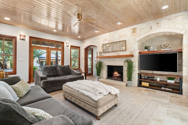 11949 Overlook Pass, Austin, TX 78738 - living area featuring wood ceiling, recessed lighting, ceiling fan, a stone fireplace, and stone tile floors