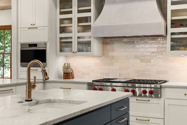 11949 Overlook Pass, Austin, TX 78738 - kitchen with premium range hood, white cabinets, and light stone counters
