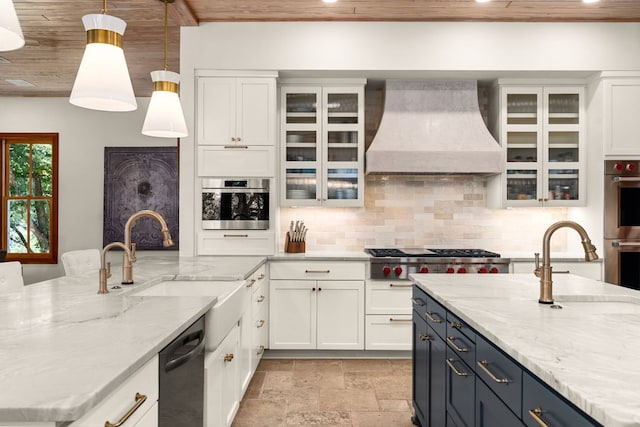 11949 Overlook Pass, Austin, TX 78738 - kitchen with custom exhaust hood, stainless steel appliances, light stone finish flooring, white cabinets, and tasteful backsplash