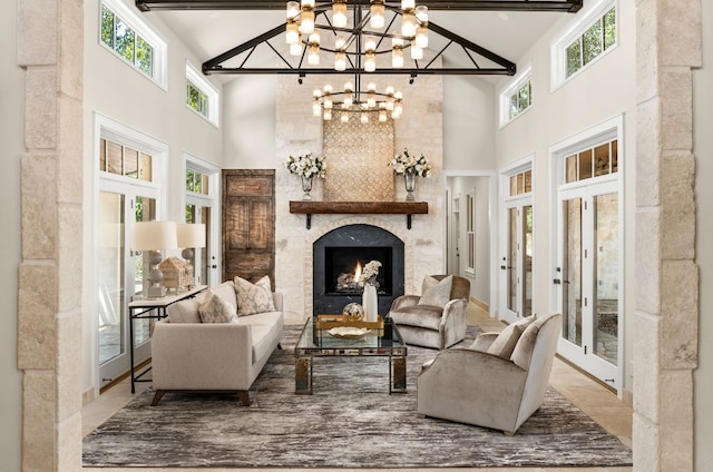 11949 Overlook Pass, Austin, TX 78738 - living area with a towering ceiling, a chandelier, a large fireplace, and plenty of natural light