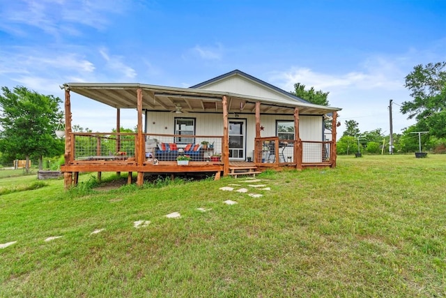 726 Mesa Dr, Del Valle, TX 78617 - rear view of property with a yard, ceiling fan, and a wooden deck