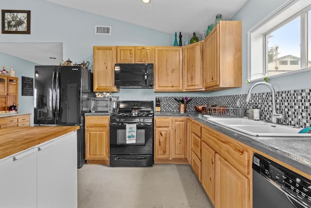 726 Mesa Dr, Del Valle, TX 78617 - kitchen with black appliances, a sink, lofted ceiling, concrete floors, and tasteful backsplash